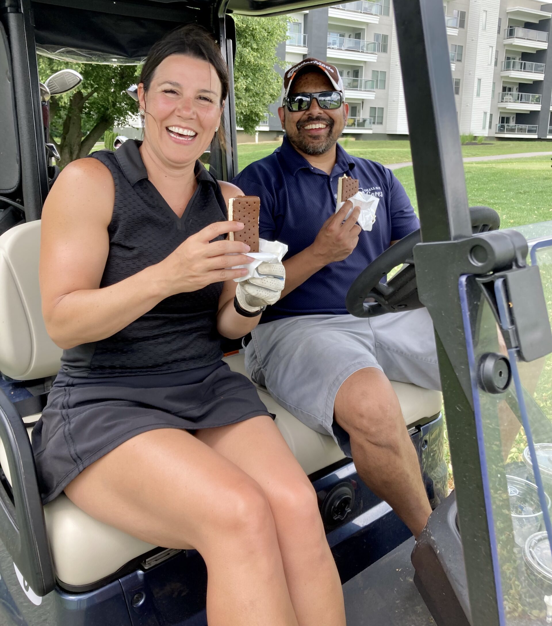 Kori_Nevin_Golf21 Kori Manus of Heartland Bank and Nevin Bansal of Outreach Promotional Solutions enjoy their ice cream sandwiches from Velvet Ice Cream!